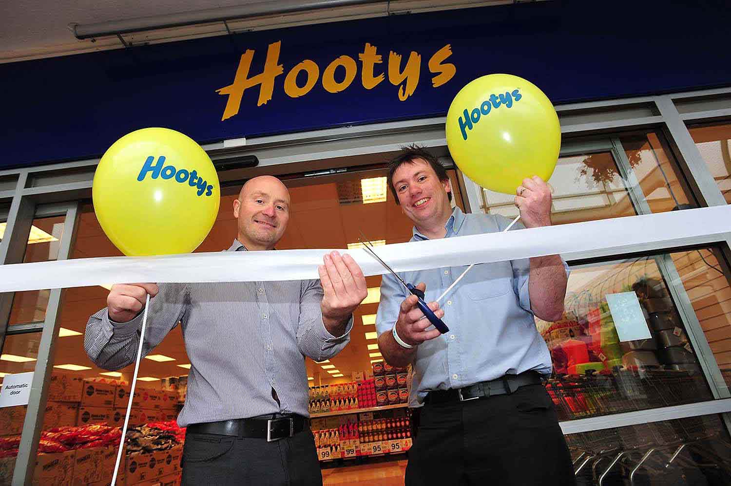 hootys store opening in Erdington in Birmingham. 2  men cut ribbon  image taken for pr news release. by picturepress  photography