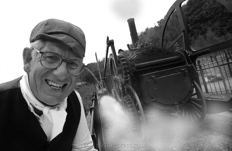 tv presenter with old steam locomotive engine.  image produced for tv listings magazines by mike kelly photographer